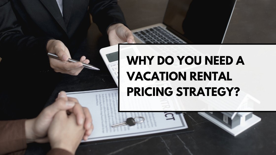 Business meeting discussing vacation rental pricing strategy with laptop, contract, keys, and calculator on the table.